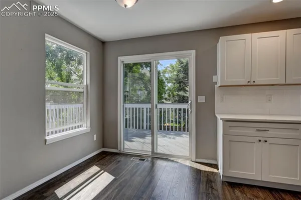 a view of a room with wooden floor and balcony