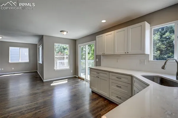 a view of a kitchen with sink and cabinets