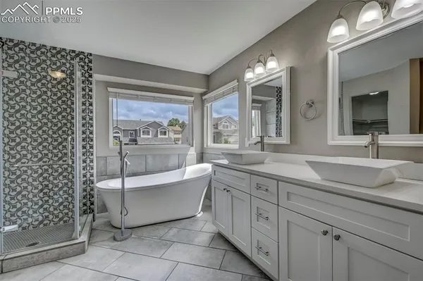 a bathroom with a double vanity sink a mirror and a bathtub