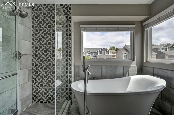 a room with a large window and chairs