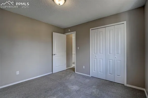 an empty room with closet area