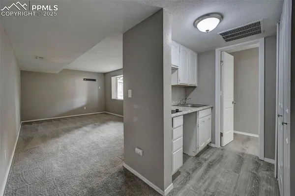 a view of a hallway with wooden cabinets