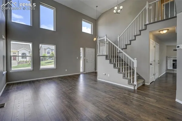 a view of an entryway with wooden floor