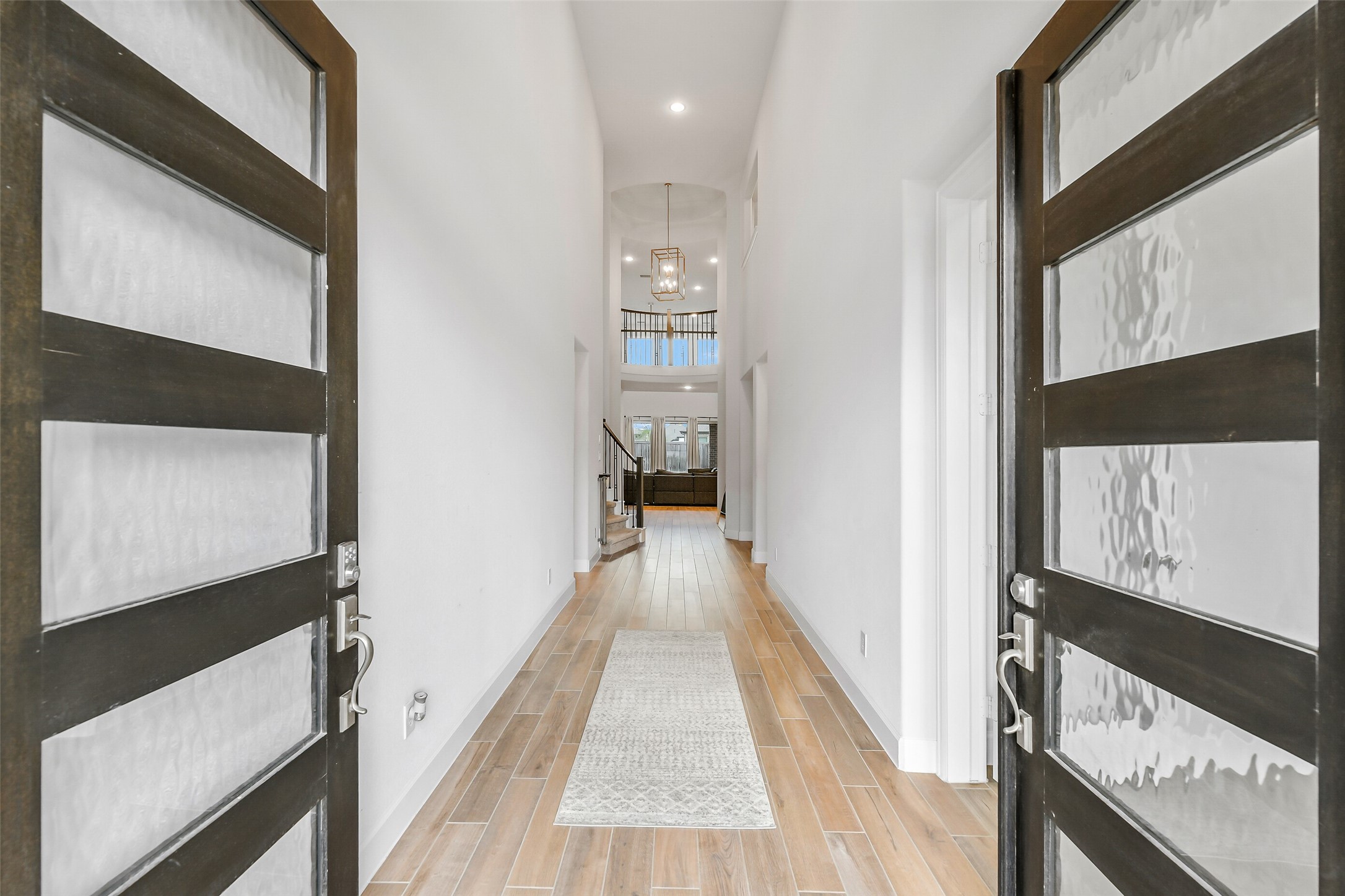 21222 Rabbitbrush Court Cypress, TX 77433 - Photo 3 of 36 a view of a hallway with wooden floor and staircase