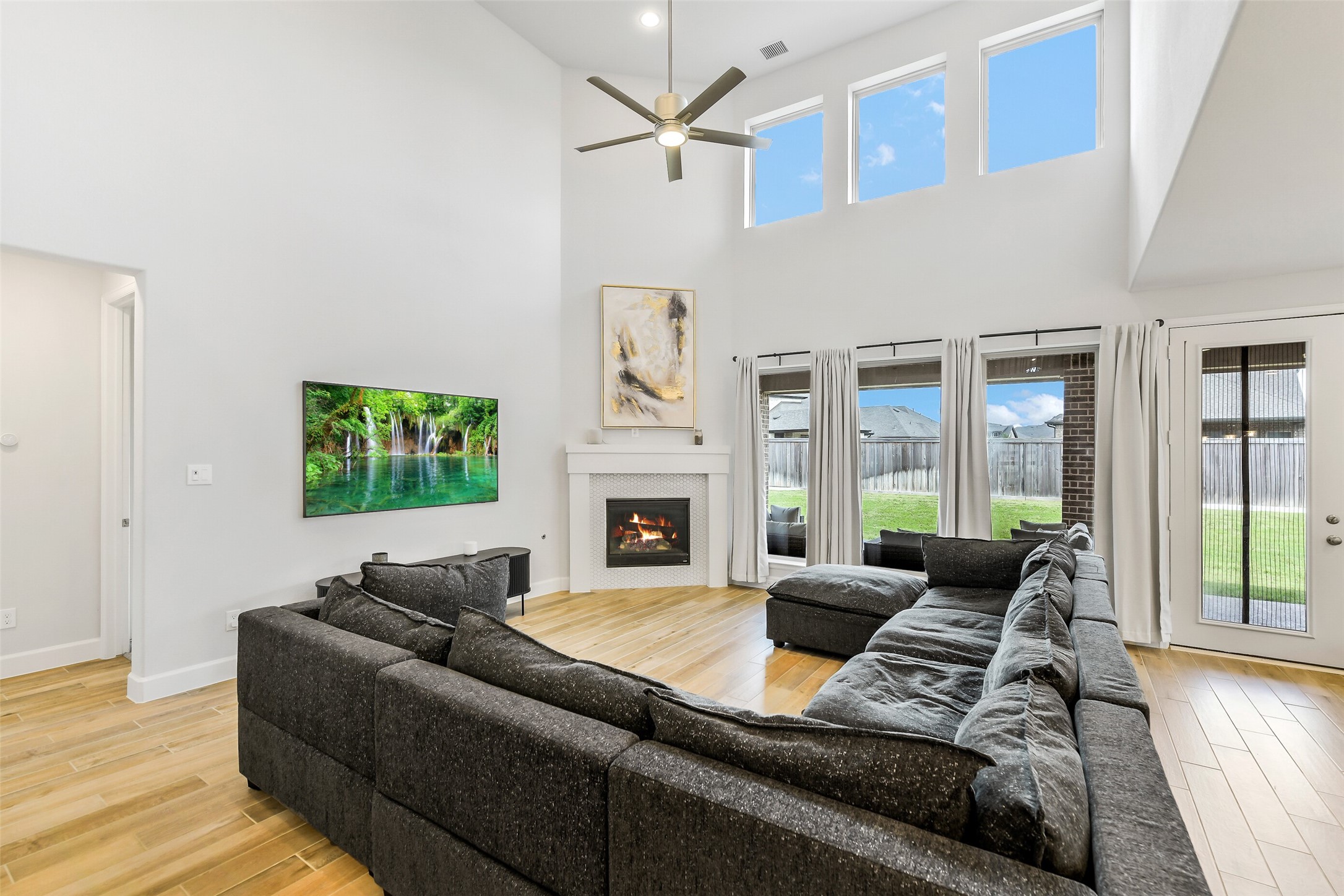 21222 Rabbitbrush Court Cypress, TX 77433 - Photo 5 of 36 a living room with furniture a fireplace and a large window