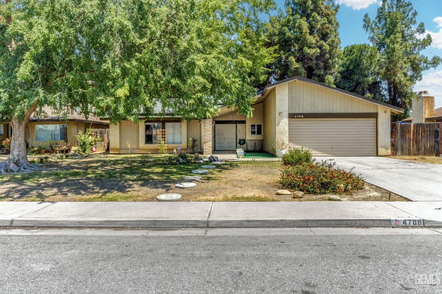 Undisclosed Address Bakersfield, CA 93313 - Photo 1 of 24 front view of house next to a yard