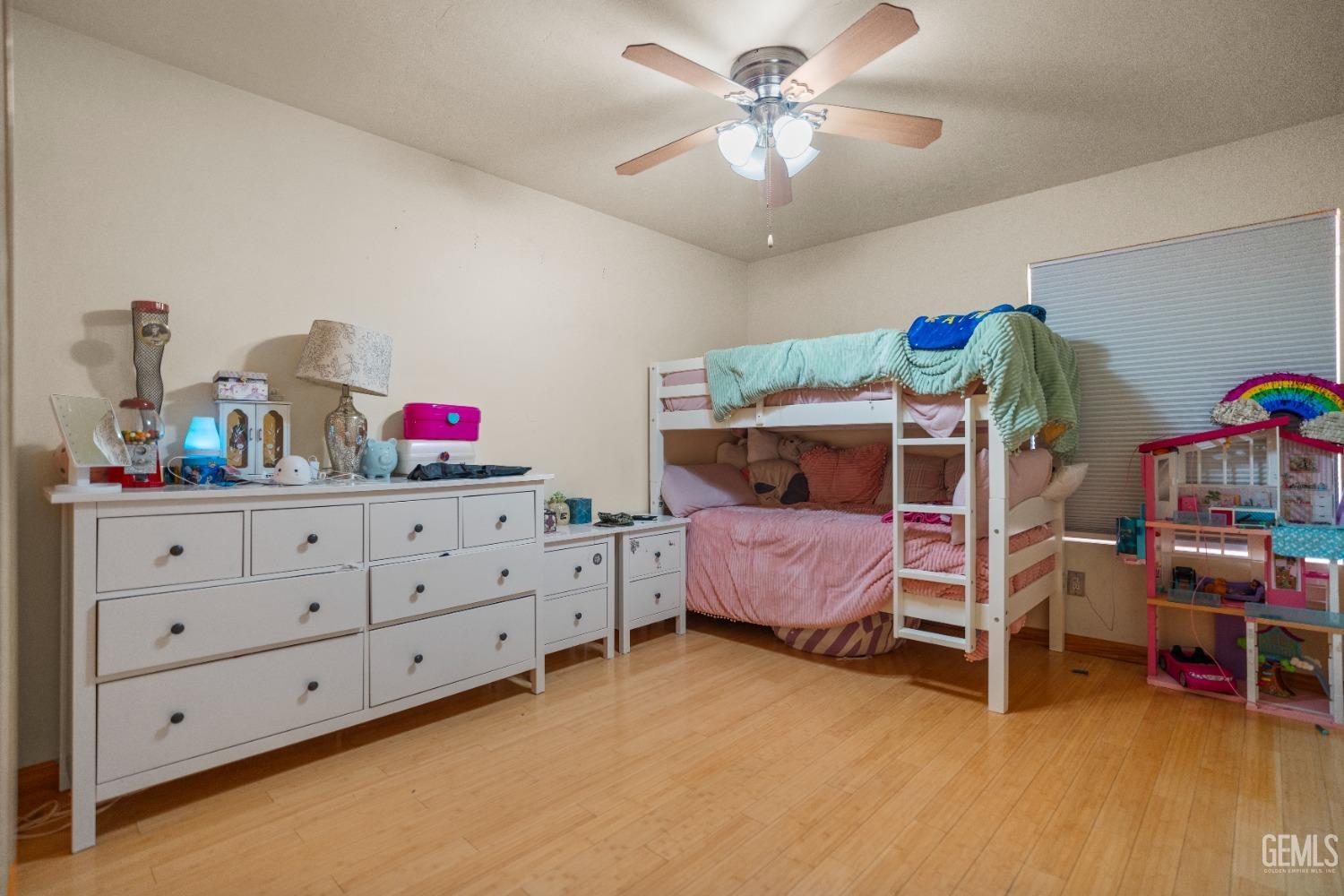 Undisclosed Address Bakersfield, CA 93313 - Photo 12 of 24 a bedroom with furniture and a chandelier fan