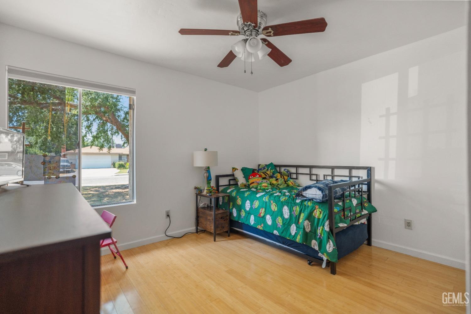 Undisclosed Address Bakersfield, CA 93313 - Photo 14 of 24 a view of a room with toys and a ceiling fan
