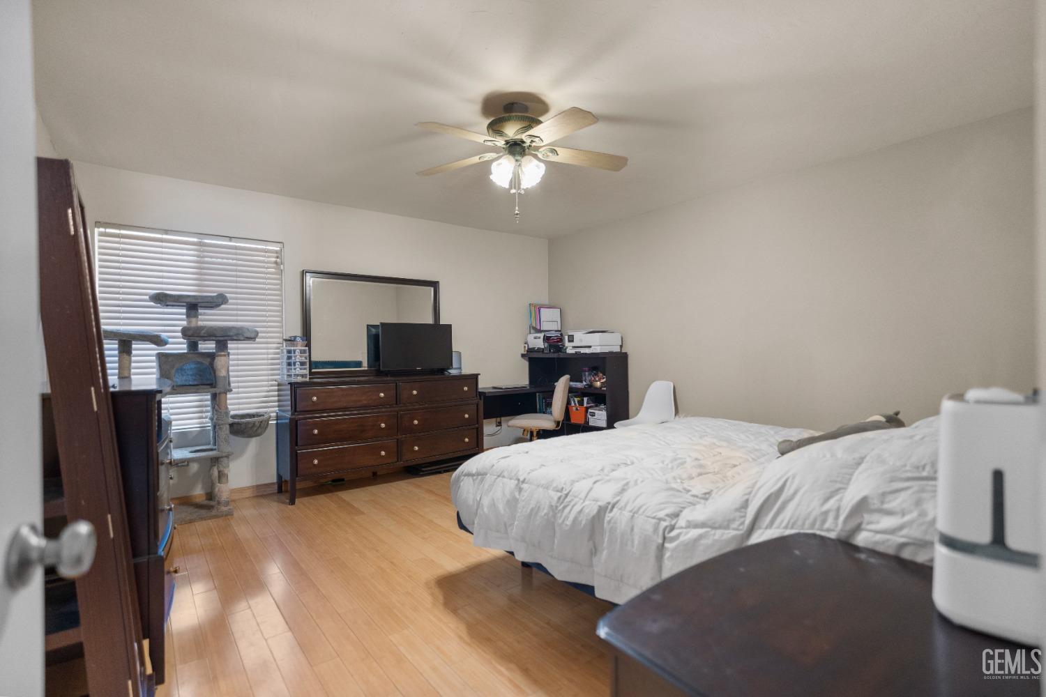Undisclosed Address Bakersfield, CA 93313 - Photo 15 of 24 a bedroom with a bed a dresser and flat screen tv