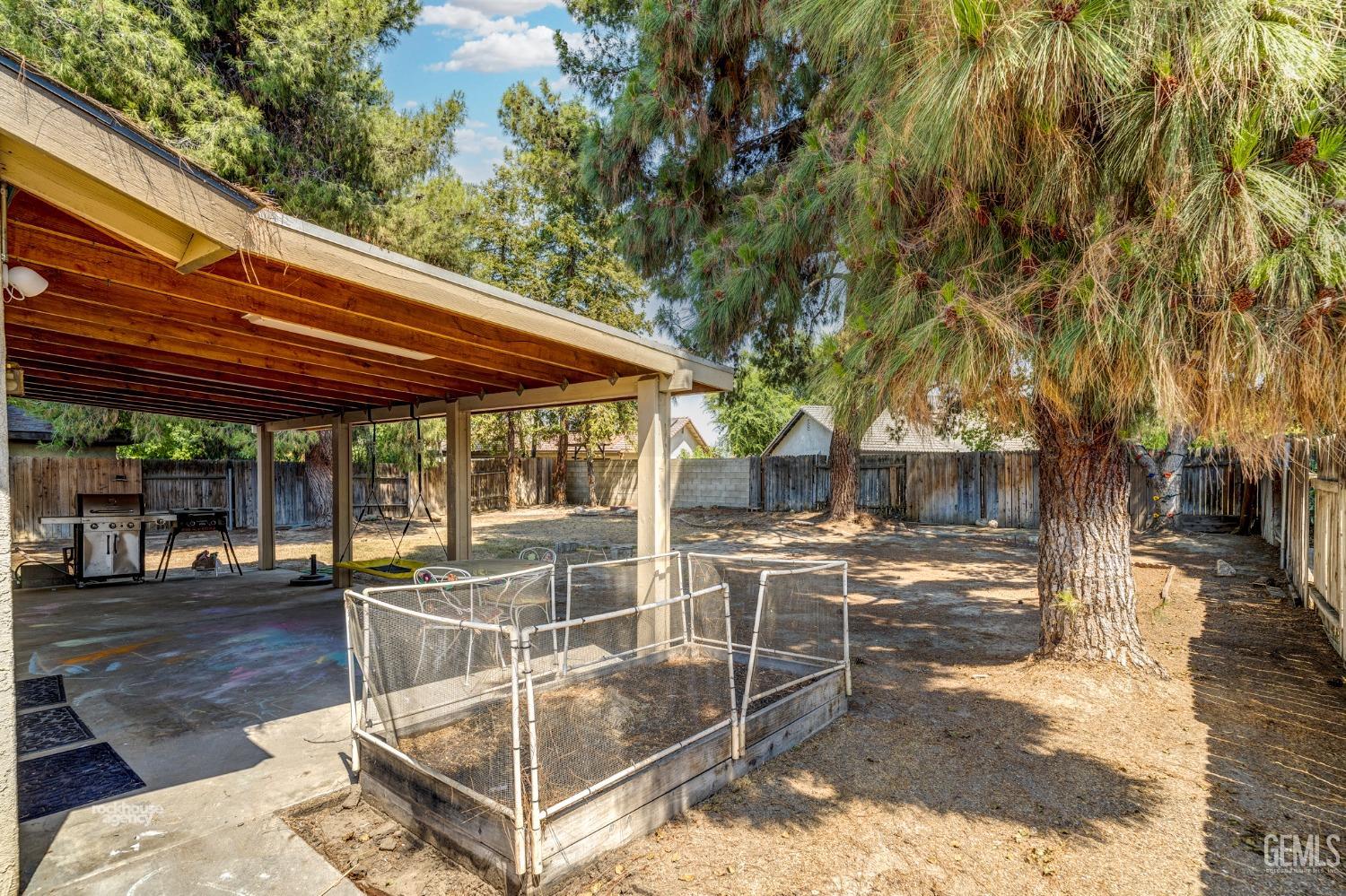 Undisclosed Address Bakersfield, CA 93313 - Photo 20 of 24 a view of a patio with a table and chairs under an umbrella