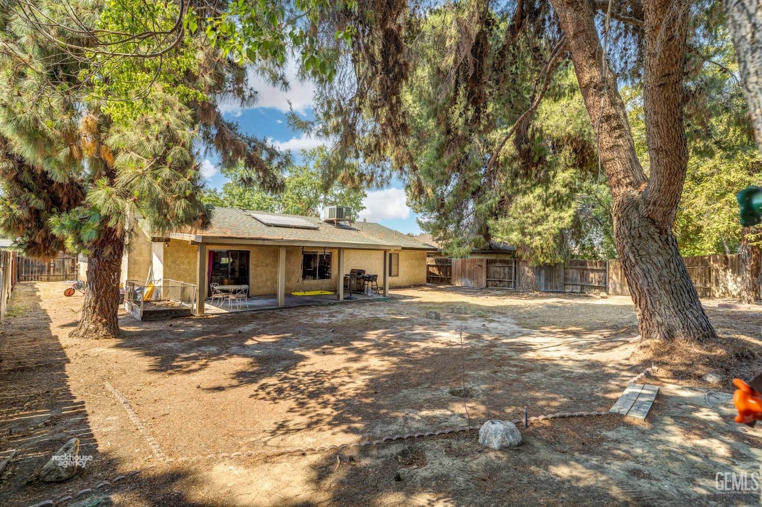 Undisclosed Address Bakersfield, CA 93313 - Photo 23 of 24 a view of a yard in front of a house with large trees