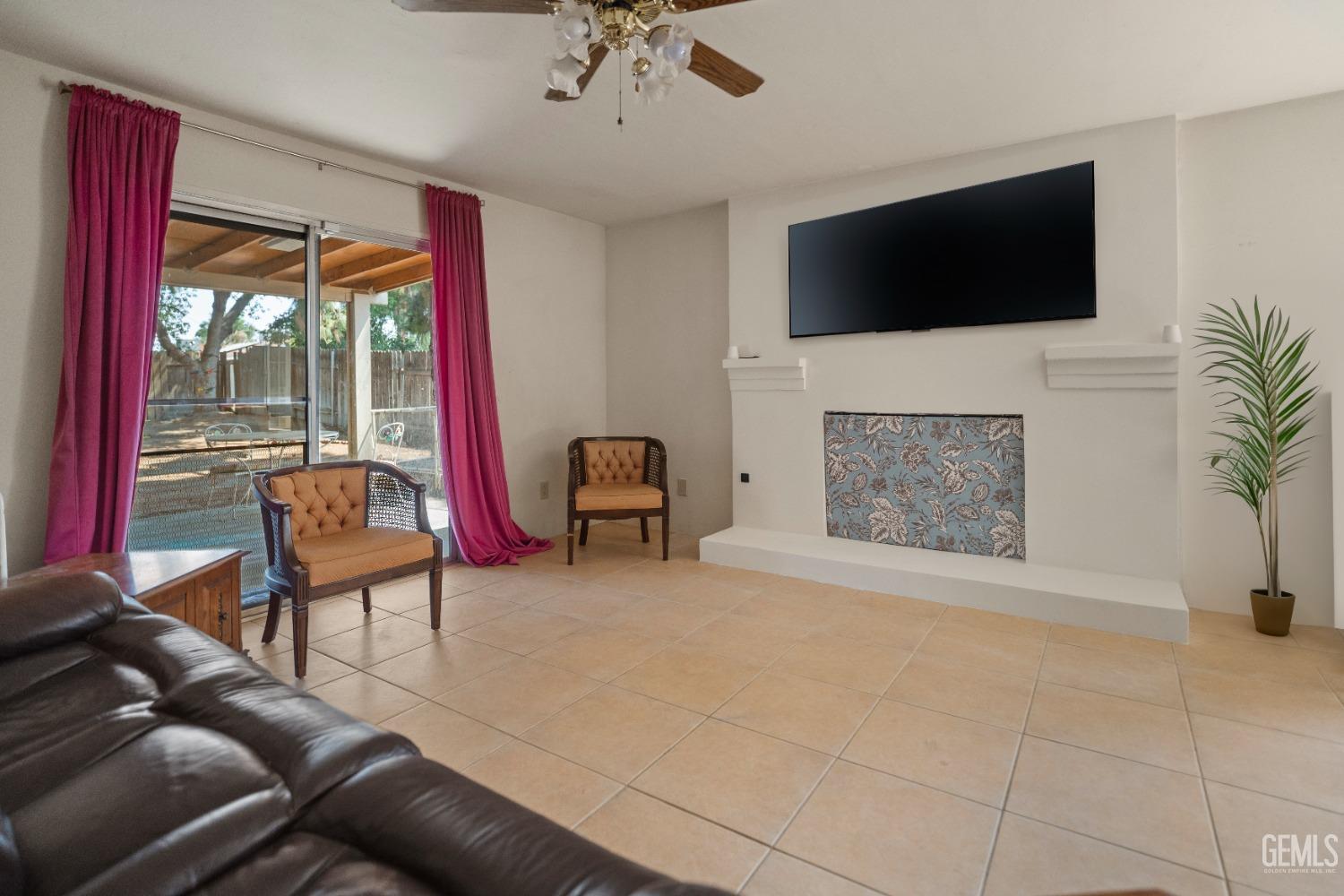 Undisclosed Address Bakersfield, CA 93313 - Photo 6 of 24 a living room with furniture and a flat screen tv