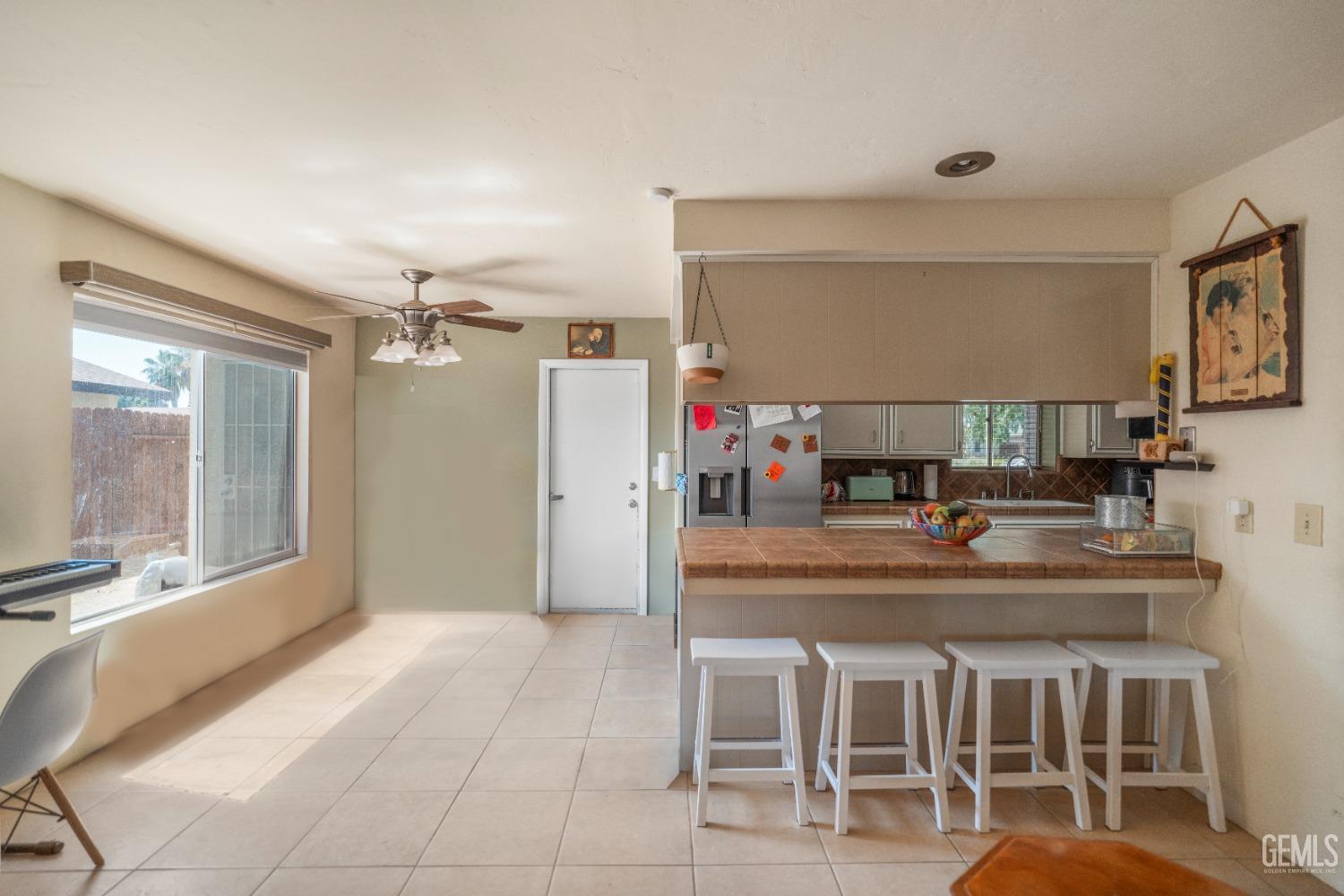 Undisclosed Address Bakersfield, CA 93313 - Photo 8 of 24 a kitchen with kitchen island granite countertop a table and chairs in it