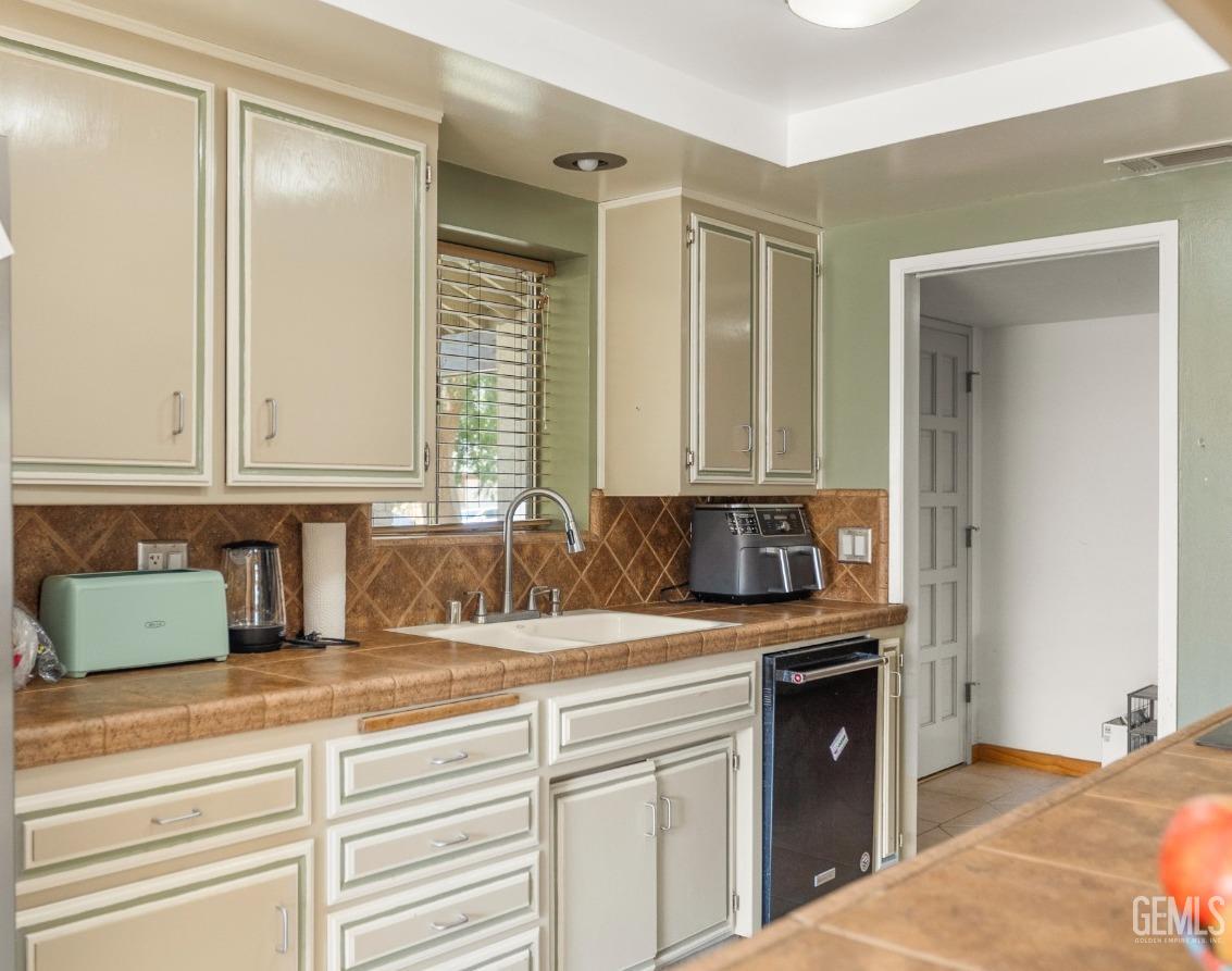 Undisclosed Address Bakersfield, CA 93313 - Photo 9 of 24 a kitchen with a sink and cabinets