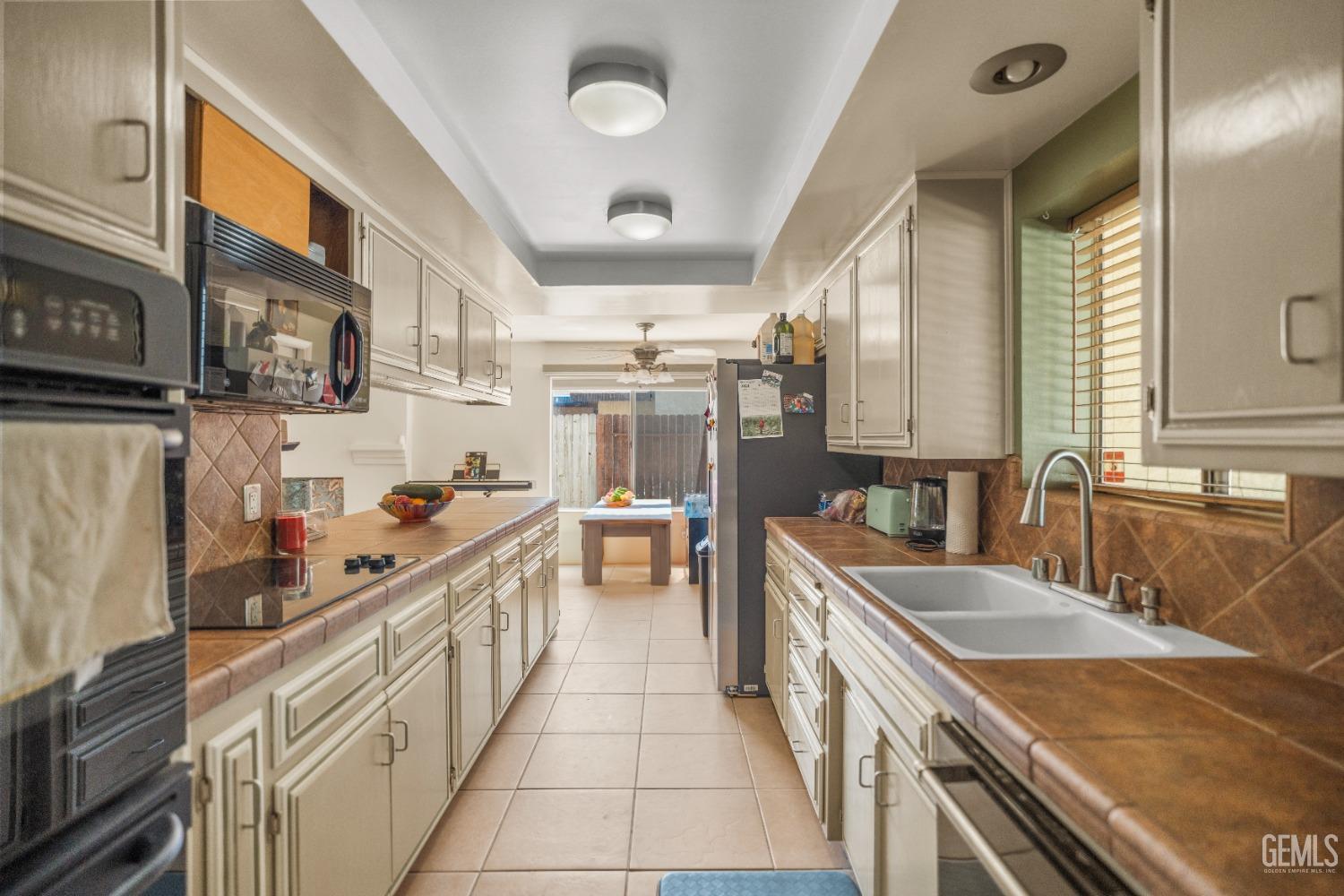 Undisclosed Address Bakersfield, CA 93313 - Photo 10 of 24 a kitchen with stainless steel appliances granite countertop a sink stove and refrigerator