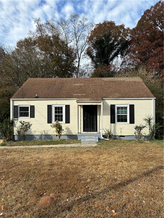 a front view of house with yard in front of it