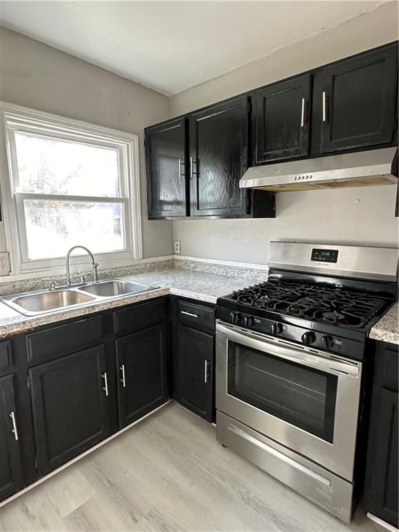 2647 Baker Ridge Drive Northwest Atlanta, GA 30318 - Photo 12 of 39 a kitchen with wooden cabinets and a stove top oven