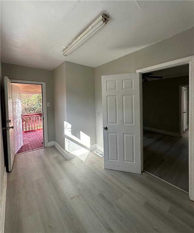 2647 Baker Ridge Drive Northwest Atlanta, GA 30318 - Photo 15 of 39 wooden floor in an empty room with a window
