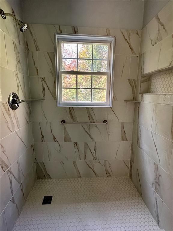 2647 Baker Ridge Drive Northwest Atlanta, GA 30318 - Photo 19 of 39 a bathroom with a window and shower