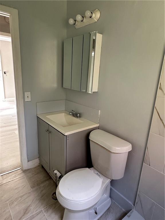 2647 Baker Ridge Drive Northwest Atlanta, GA 30318 - Photo 20 of 39 a bathroom with a toilet sink and mirror
