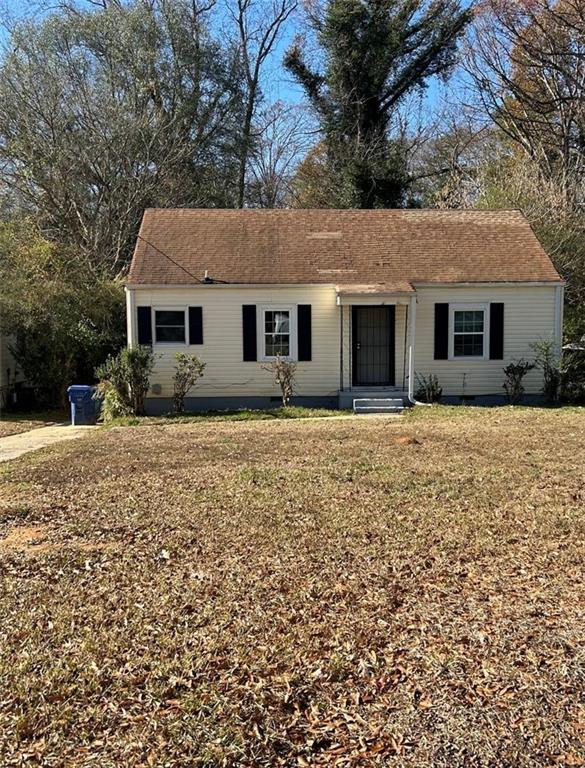 2647 Baker Ridge Drive Northwest Atlanta, GA 30318 - Photo 2 of 39 a front view of house with yard and trees