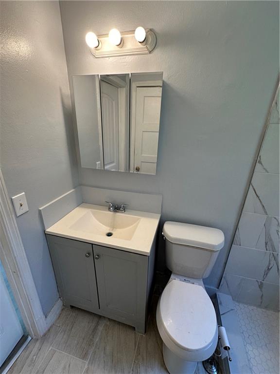 2647 Baker Ridge Drive Northwest Atlanta, GA 30318 - Photo 21 of 39 a bathroom with a toilet sink and mirror