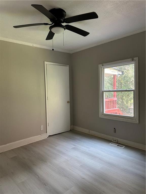 2647 Baker Ridge Drive Northwest Atlanta, GA 30318 - Photo 28 of 39 an empty room with a window and a ceiling fan