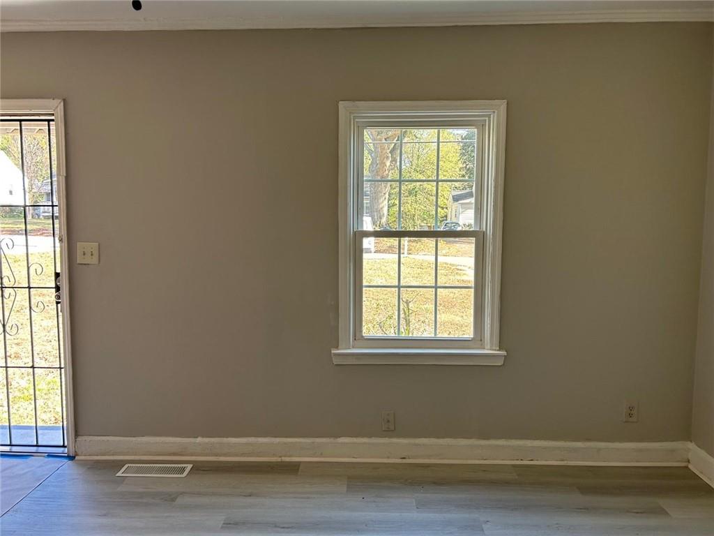 2647 Baker Ridge Drive Northwest Atlanta, GA 30318 - Photo 4 of 39 an empty room with wooden floor and a window