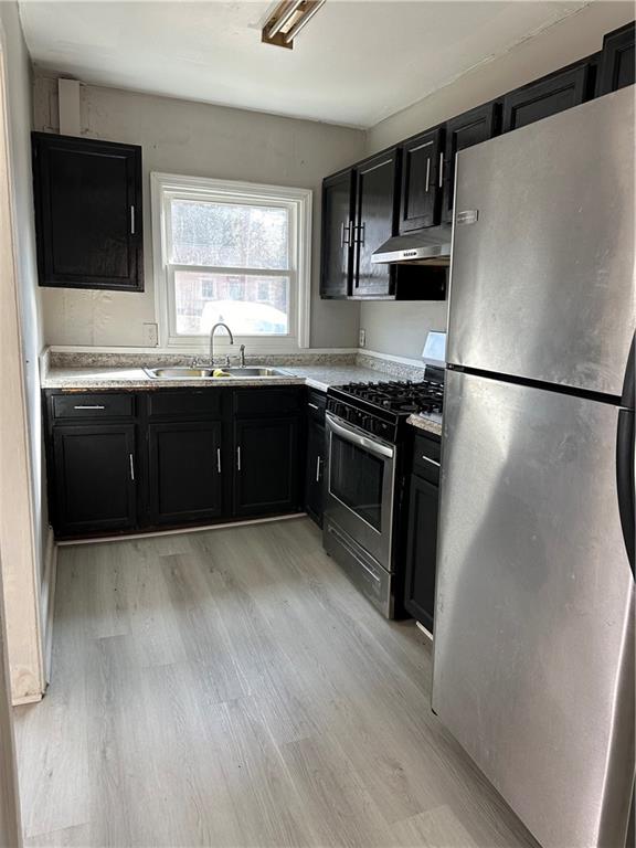 2647 Baker Ridge Drive Northwest Atlanta, GA 30318 - Photo 6 of 39 a kitchen with stainless steel appliances granite countertop a refrigerator a sink a stove a microwave and wooden floors