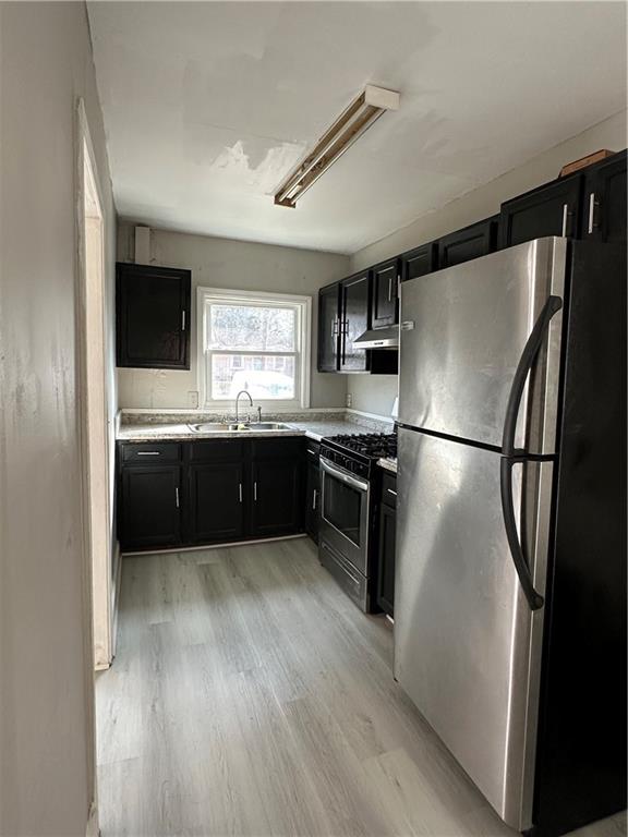 2647 Baker Ridge Drive Northwest Atlanta, GA 30318 - Photo 8 of 39 a kitchen with stainless steel appliances granite countertop a refrigerator a sink a stove a microwave and wooden floors
