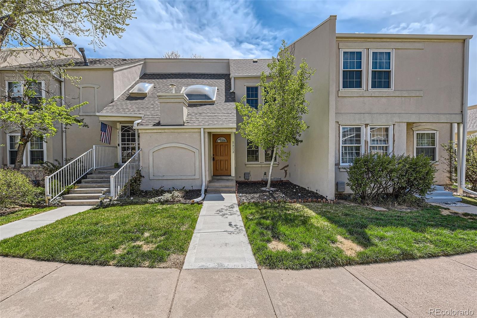 2913 South Vaughn Way Aurora, CO 80014 - Photo 1 of 30 a front view of a house with a yard
