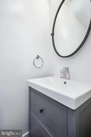 a bathroom with a sink mirror and vanity