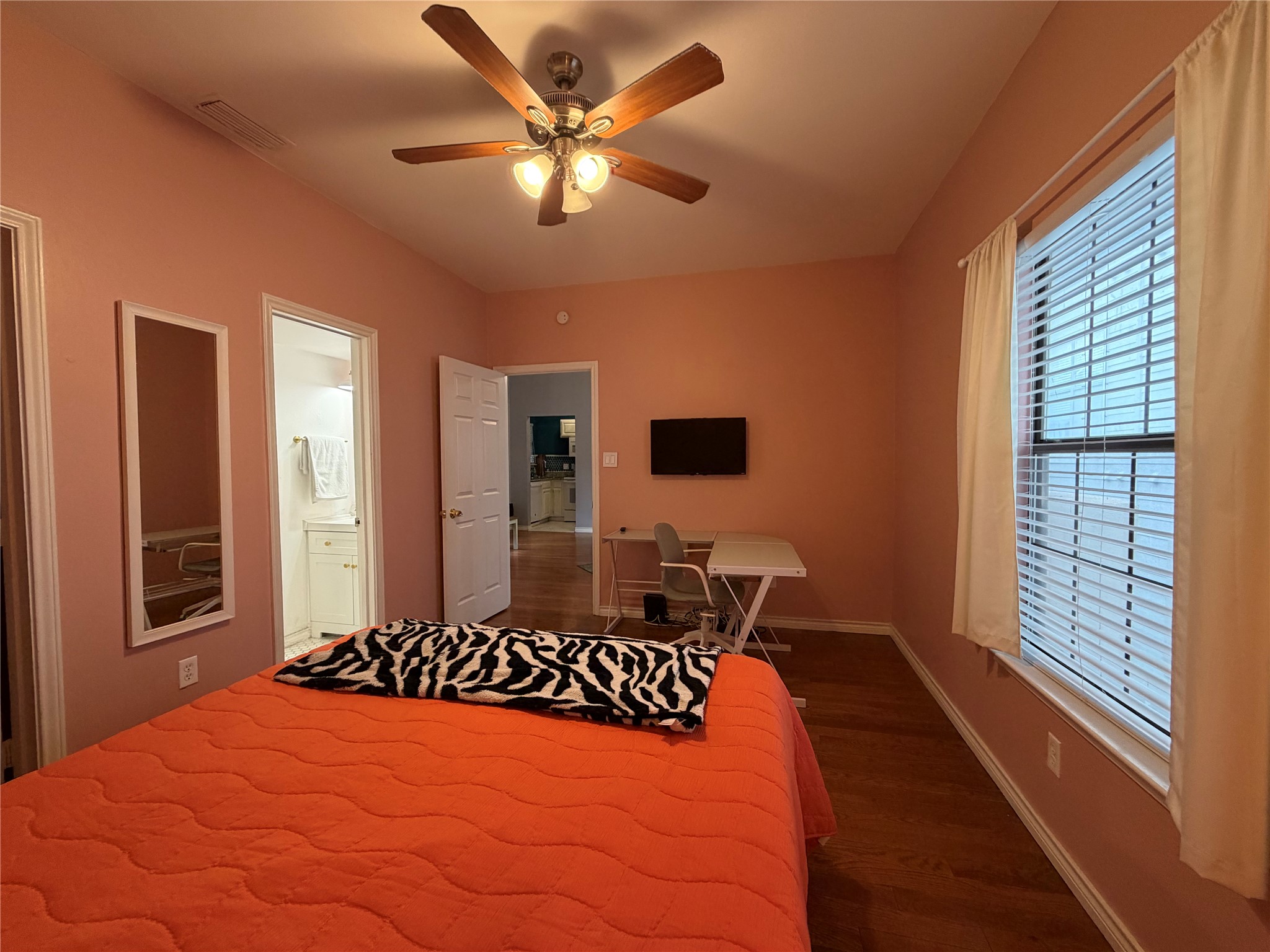 2509 Pearl Street, Unit 7 Austin, TX 78705 - Photo 13 of 23 a bedroom with a large bed and a chandelier