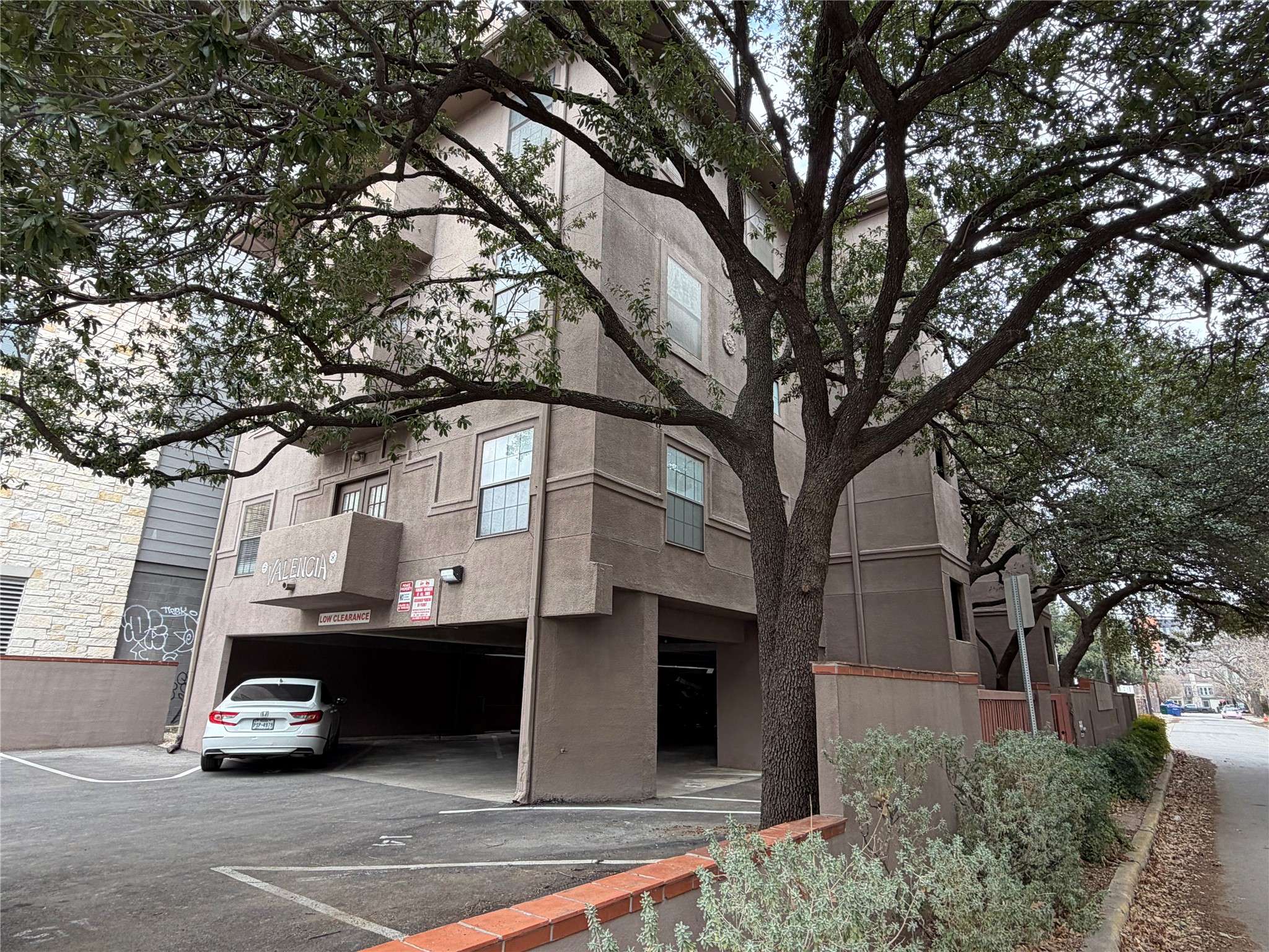 2509 Pearl Street, Unit 7 Austin, TX 78705 - Photo 21 of 23 a car parked in front of a white house