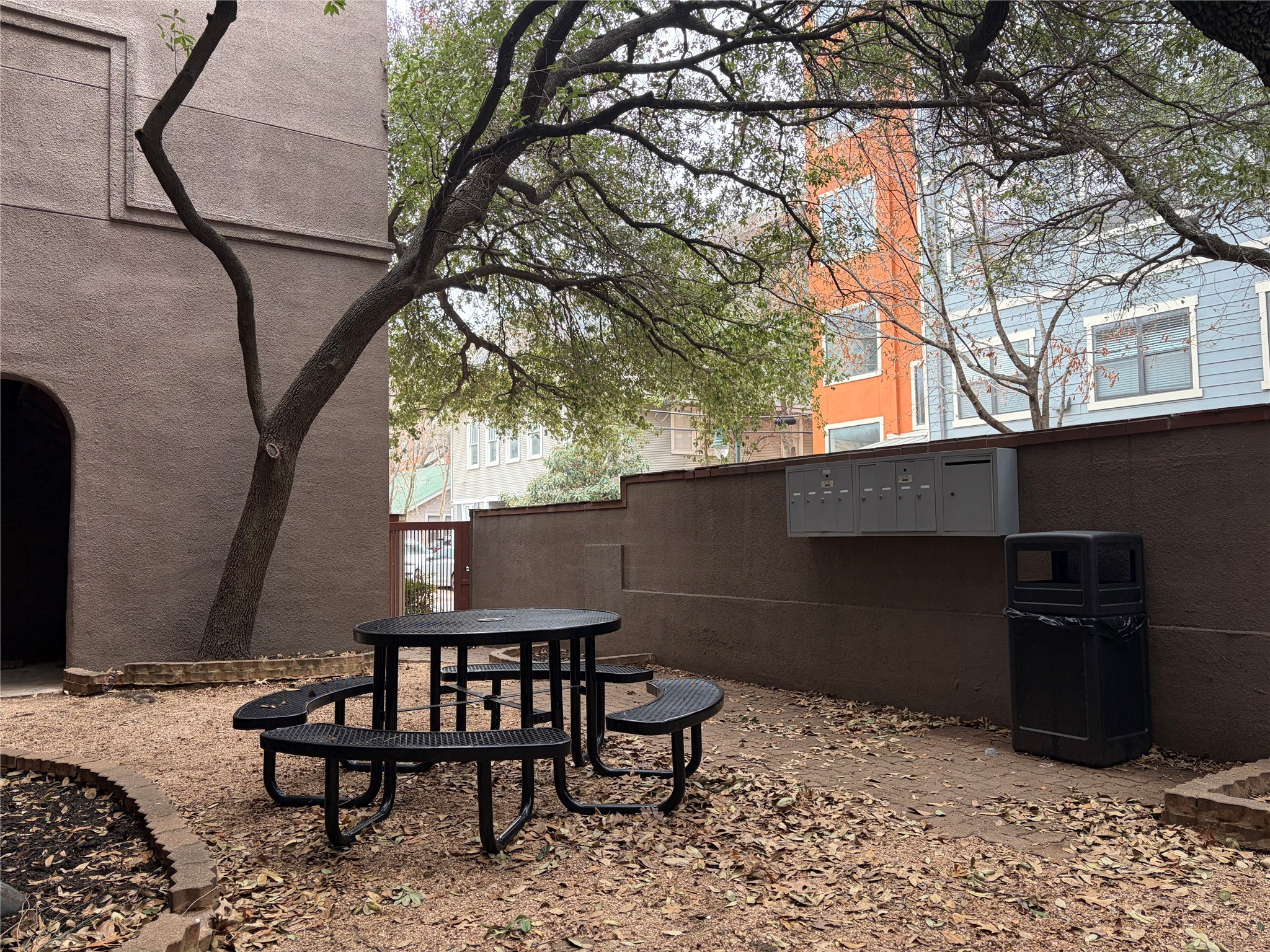 2509 Pearl Street, Unit 7 Austin, TX 78705 - Photo 22 of 23 a backyard of a house with table and chairs