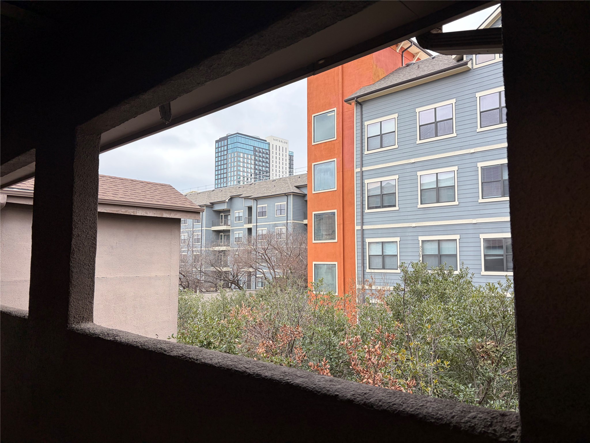 2509 Pearl Street, Unit 7 Austin, TX 78705 - Photo 23 of 23 a front view of a house with a yard and trees