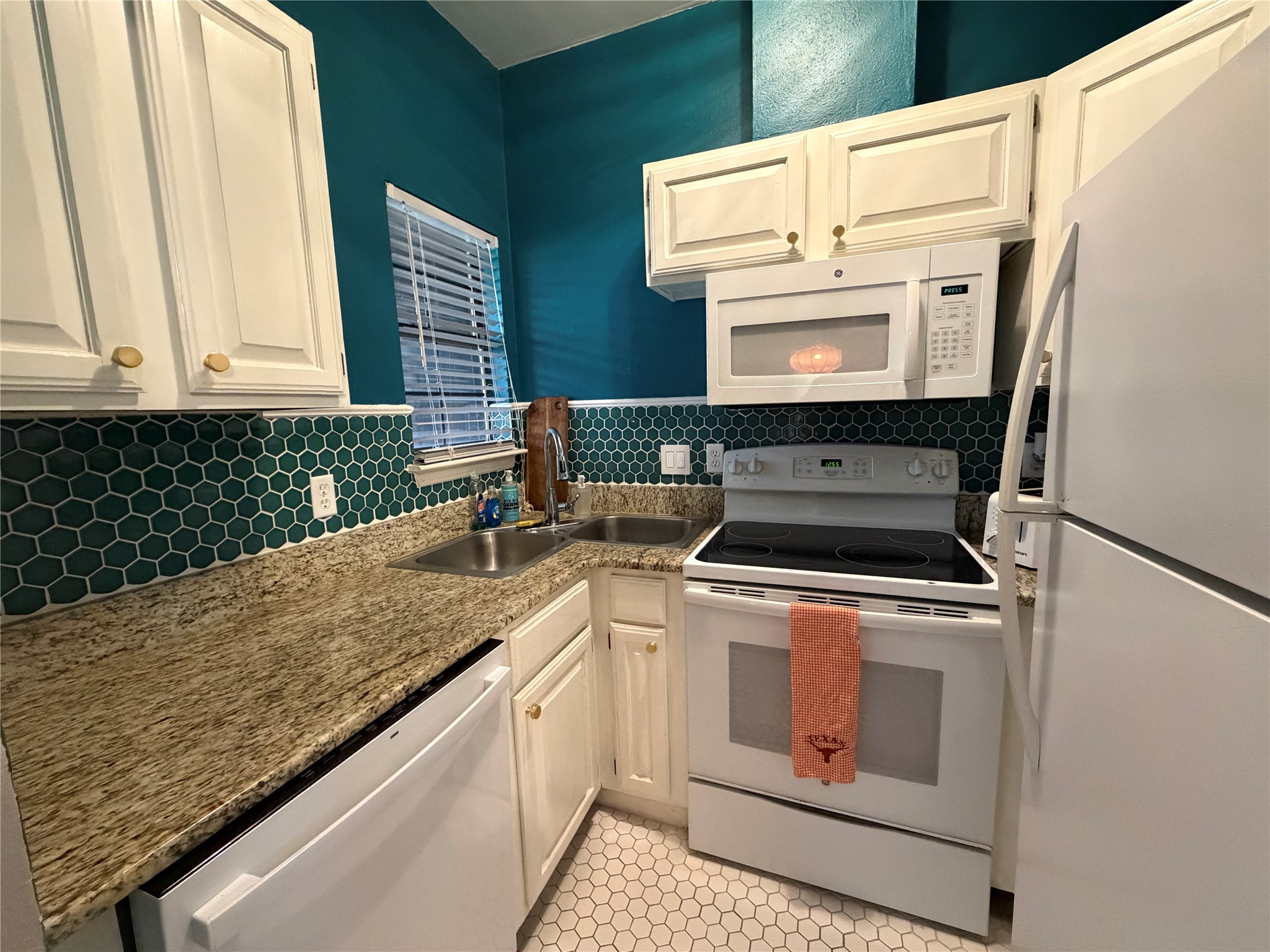 2509 Pearl Street, Unit 7 Austin, TX 78705 - Photo 4 of 23 a kitchen with granite countertop a stove sink and cabinets