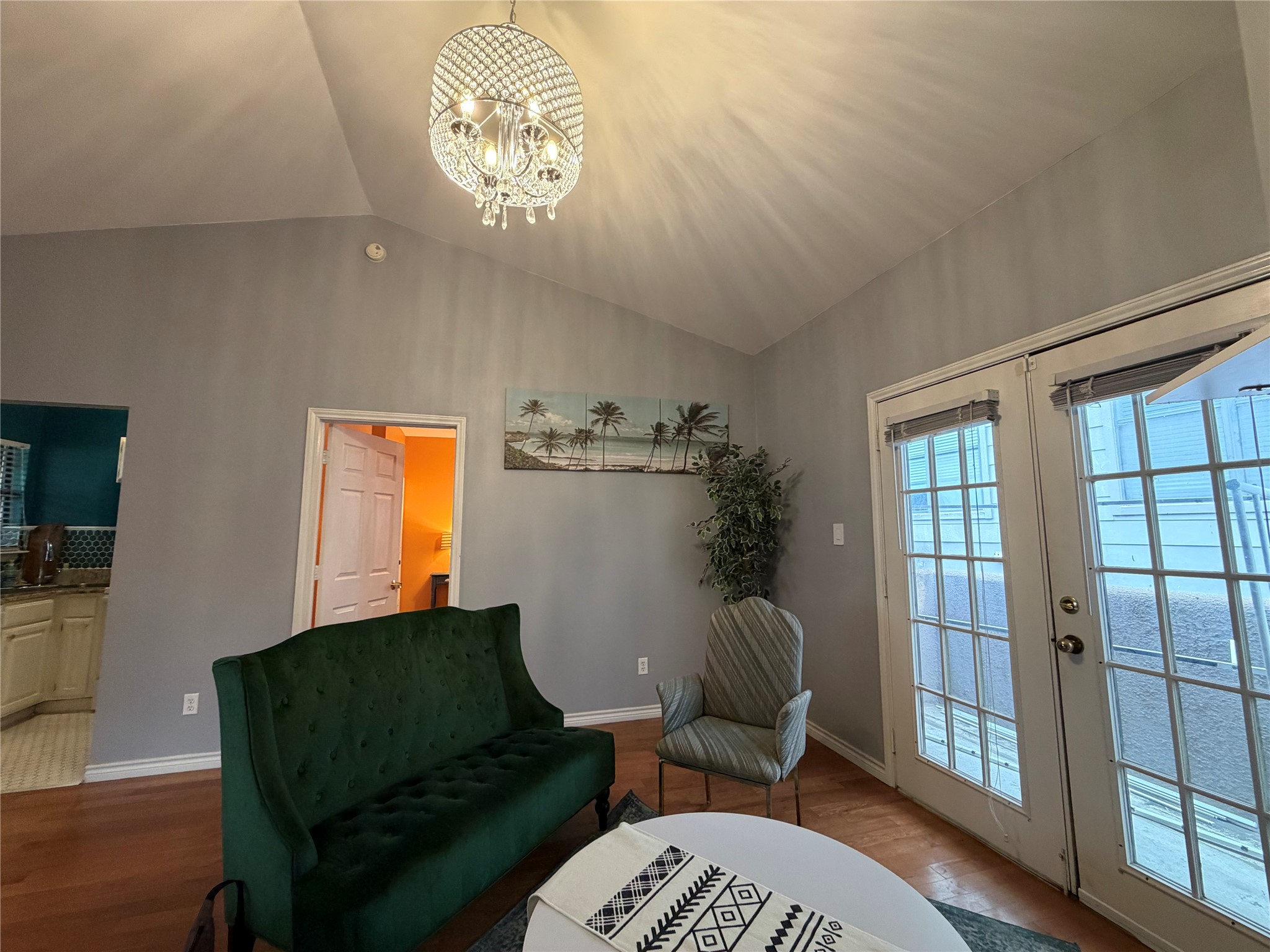 2509 Pearl Street, Unit 7 Austin, TX 78705 - Photo 7 of 23 a living room with furniture and a chandelier