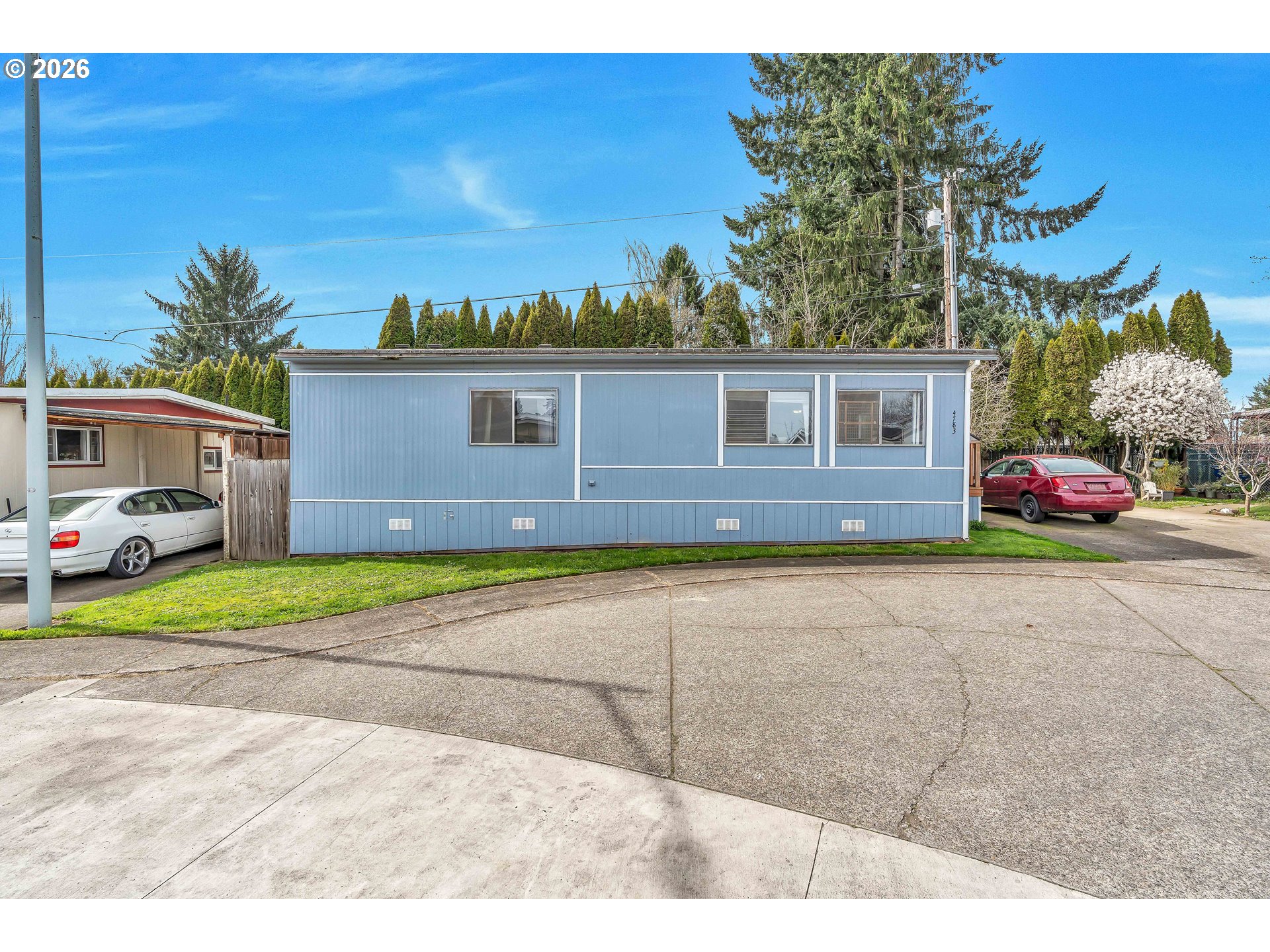 a front view of a house with a yard and a garage