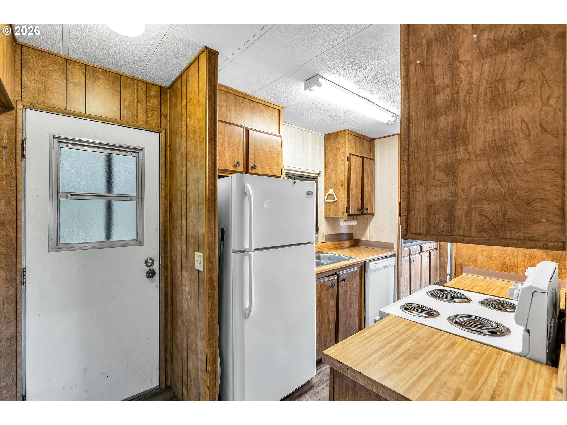 4783 Joyce Street, Unit 93 Keizer, OR 97303 - Photo 11 of 33 a kitchen with a refrigerator a stove top oven a sink and dishwasher