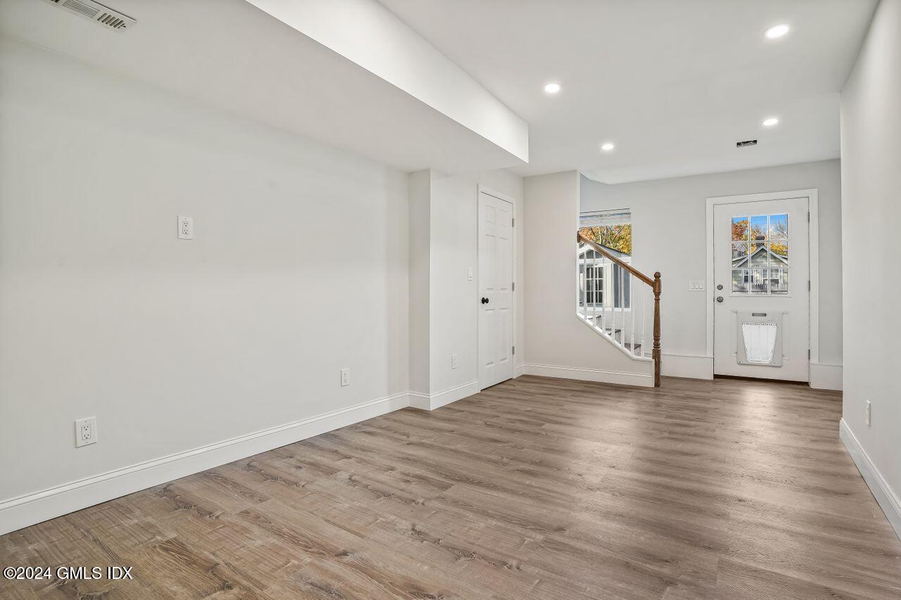 52 Le Grande Avenue, Unit 2 Greenwich, CT 06830 - Photo 19 of 31 a view of empty room with wooden floor