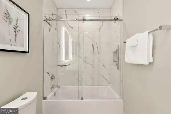 a bathroom with a bathtub and a shower