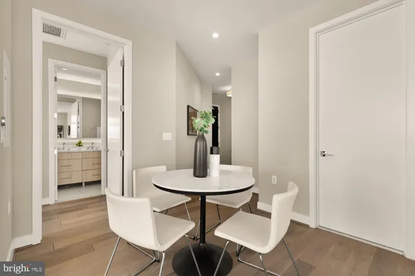 a dining room with furniture and wooden floor