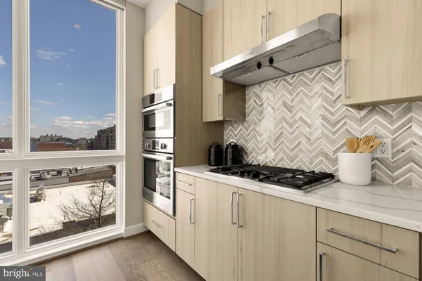 a kitchen with stainless steel appliances granite countertop a stove and a microwave