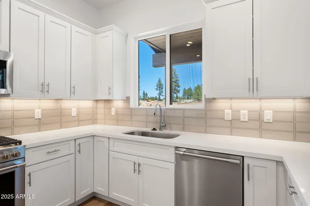a kitchen with a sink cabinets and window