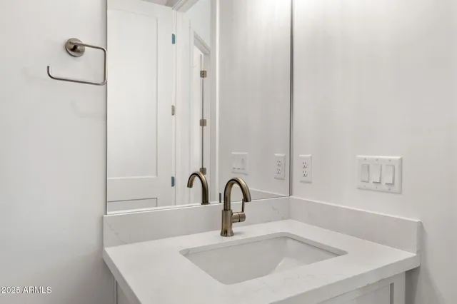 a bathroom with a sink and mirror