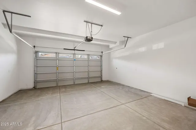 a view of a hallway with wooden floor and a bathroom