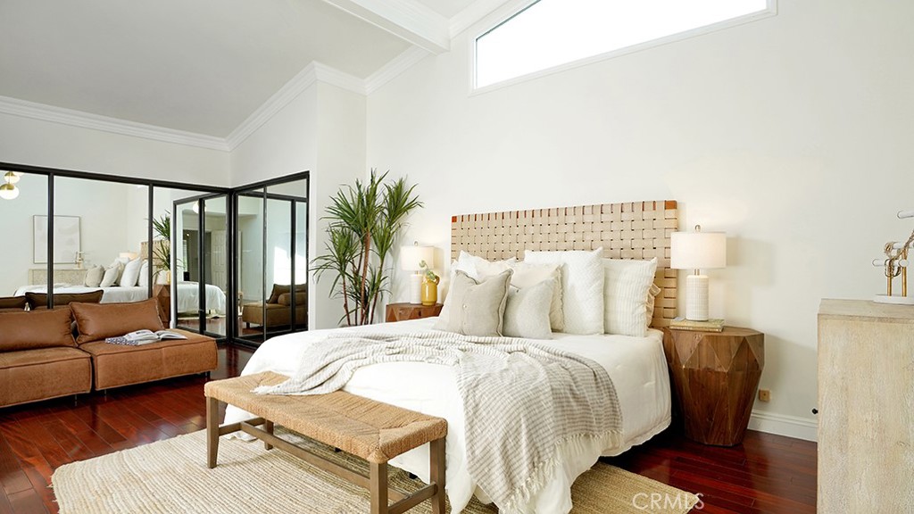 25312 Pizarro Road Lake Forest, CA 92630 - Photo 14 of 36 a bedroom with a large bed and a couch next to a window