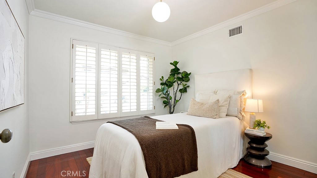 25312 Pizarro Road Lake Forest, CA 92630 - Photo 16 of 36 a bedroom with a bed and a potted plant