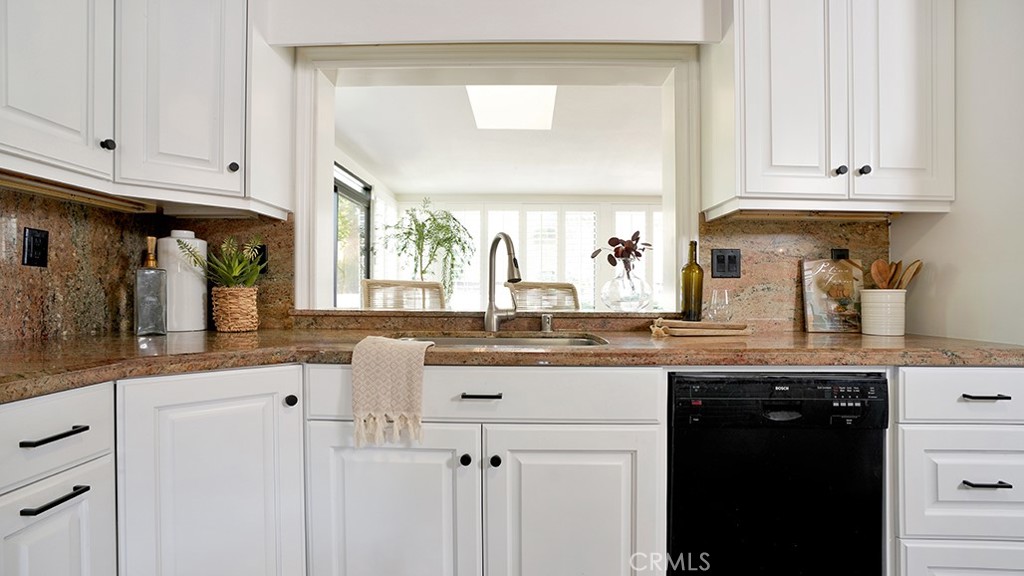 25312 Pizarro Road Lake Forest, CA 92630 - Photo 22 of 36 a kitchen with granite countertop white cabinets and a sink